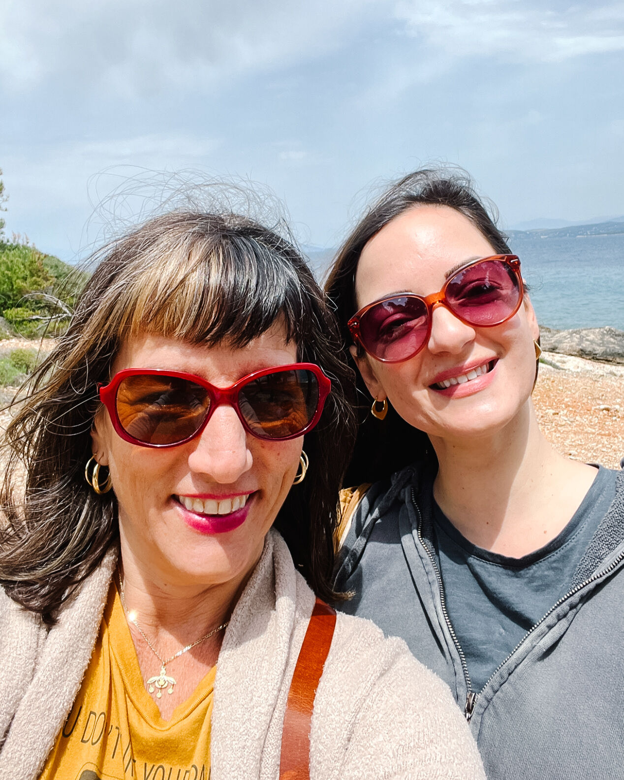 Elli Milan and Eva Bratopoulou smiling on the beaches of Greece