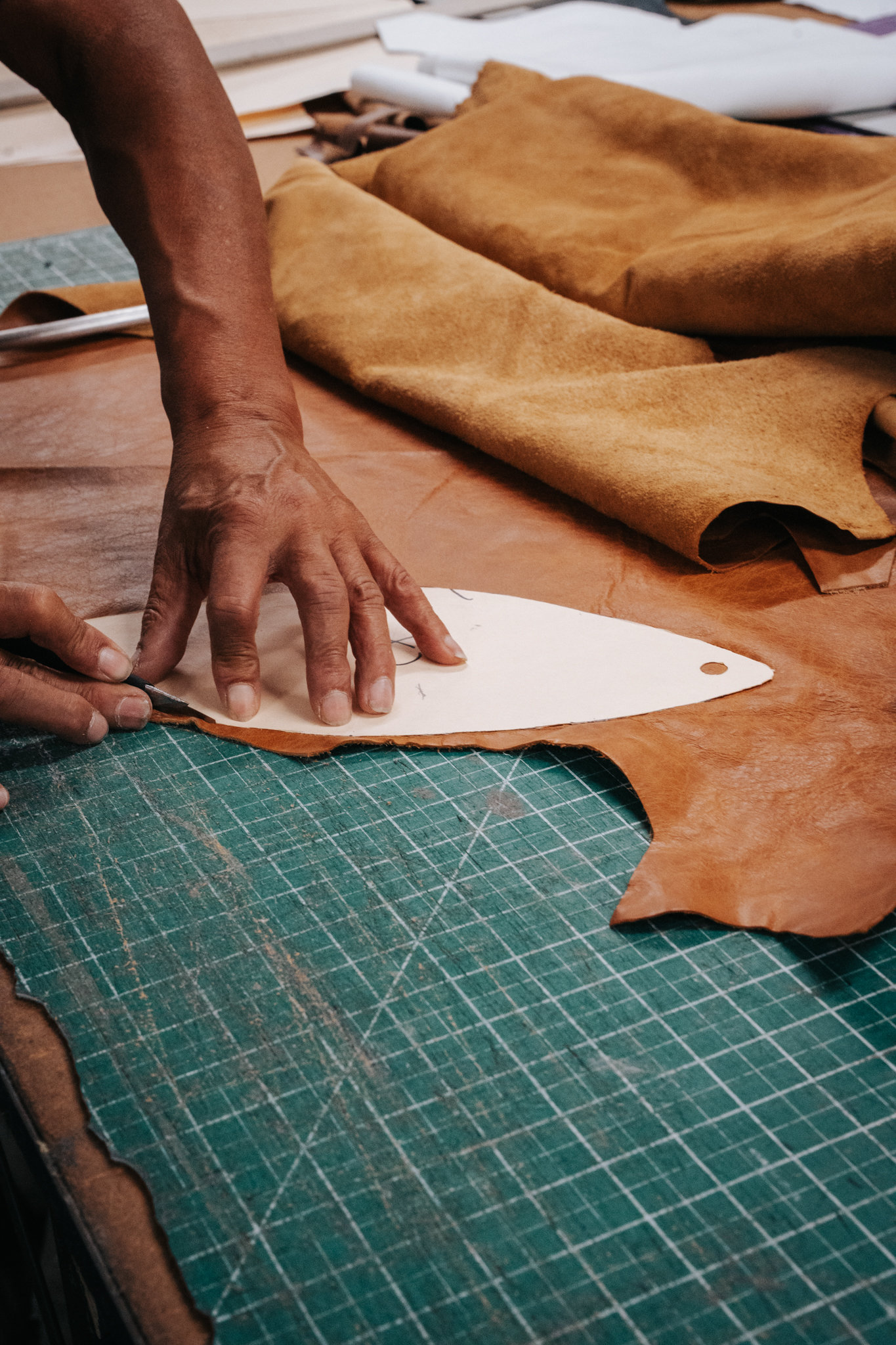 Full-grain leather being cut by hand in the iliac workshop