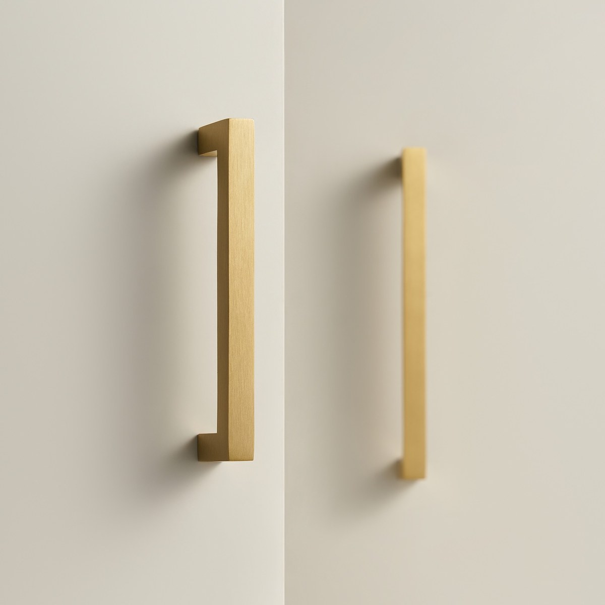 FYRA bar handles in satin brass fitted to a pair of cabinet doors