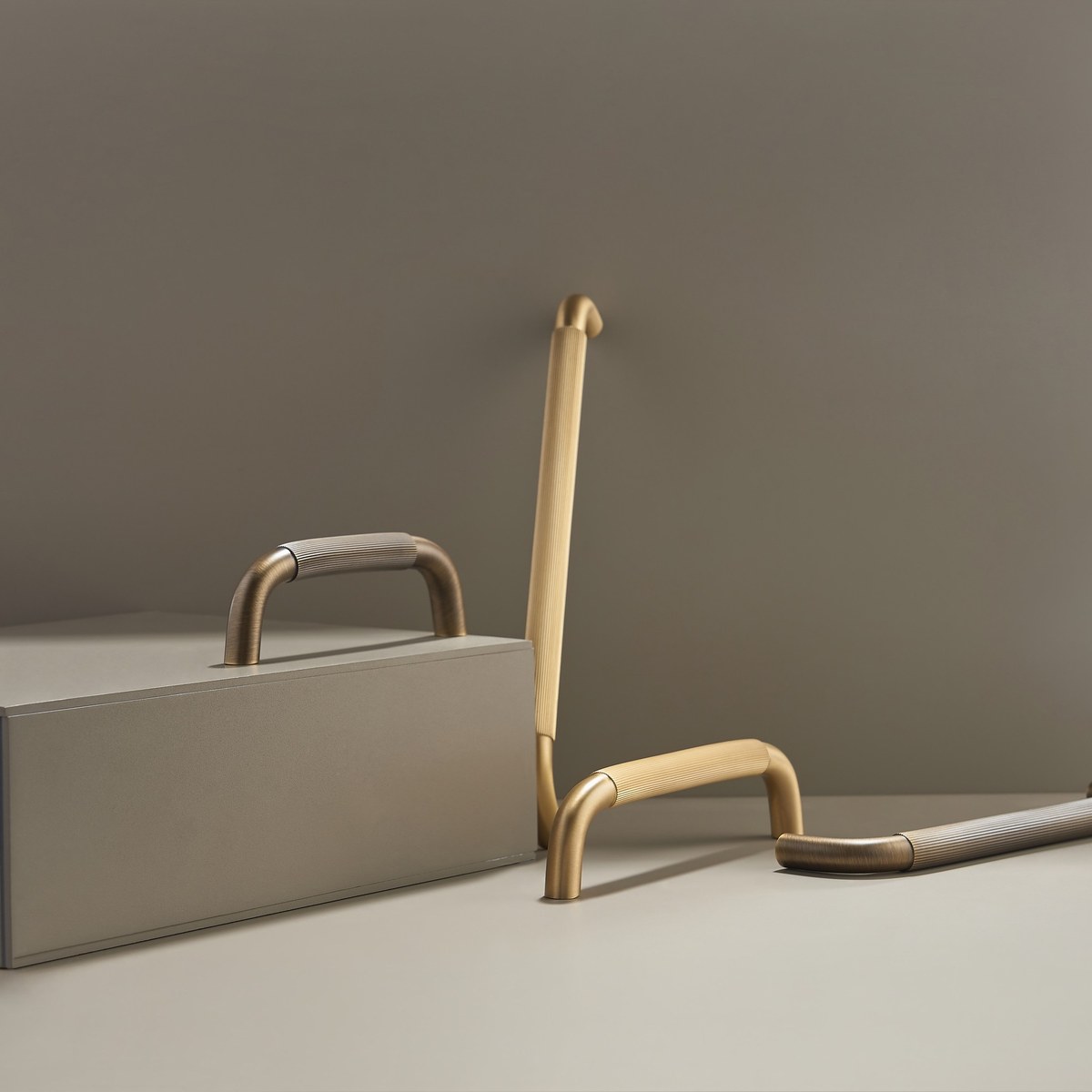 RIGA solid brass bar handles in satin brass and antique brass, styled on a plinth