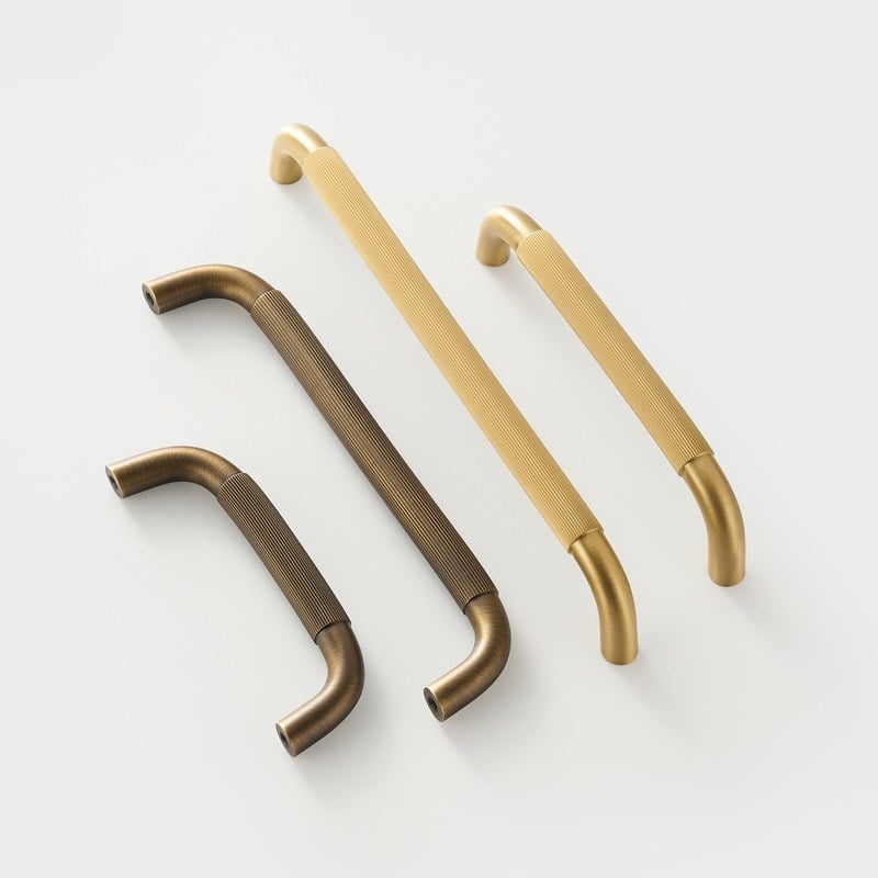 RIGA bar handles in satin brass and antique brass across the lengths