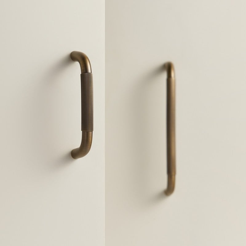RIGA bar handles in antique brass fitted to cabinet doors